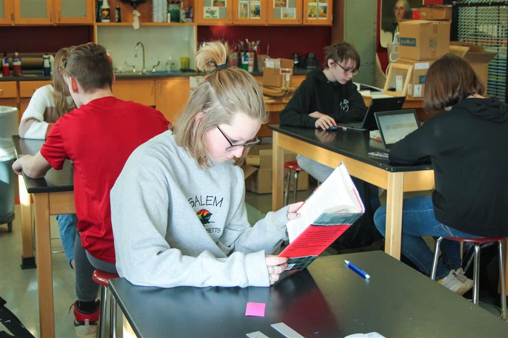 a student reads in the classroom.