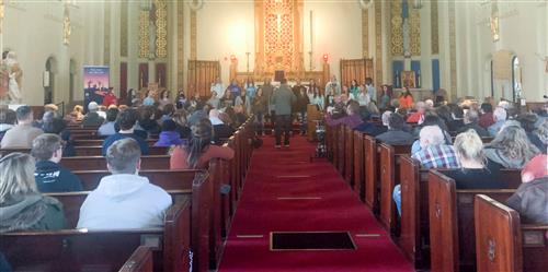 family and community members watching the ensemble preform 