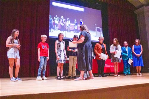 image of students on stage at Grade 6 moving up ceremony.