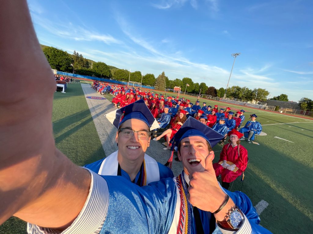 Seniors taking a selfi at graduation