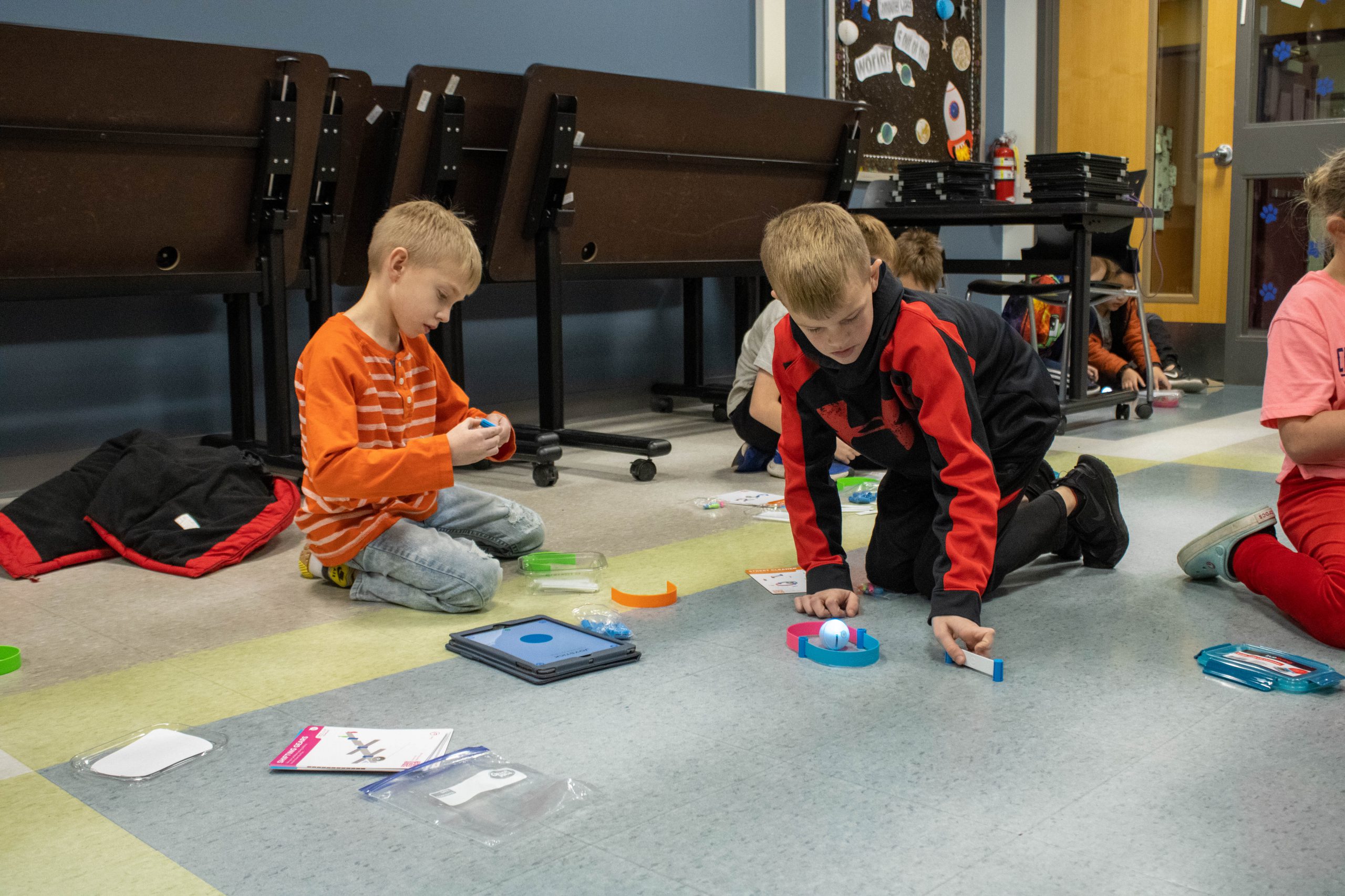 Students playing with spheros in computer class