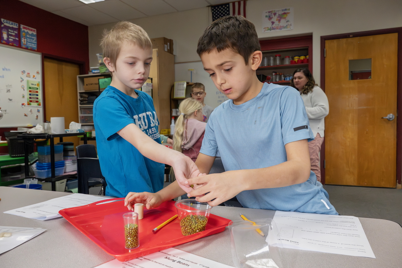 student roasts marshmallow over pretend campfire